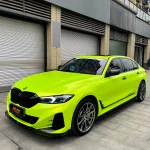 Wide side front full body shot BMW 3 Series covered with MOZX Easy Fluorescent Yellow PET Vinyl Wrap
