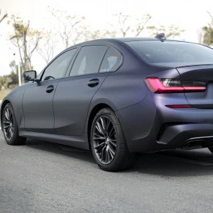 MOZX Elite Matte Midnight Purple TPU wrap on BMW 3 Series G20 sedan rear side full exterior shot, matte dark purple color change film