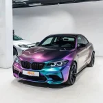 Side front 45 degree view BMW M2 MOZX Fairy Spirit Blue wrap with MOZX plate