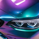 Close-up headlight detail of BMW M2 with Fairy Spirit Blue color shift PPF