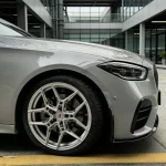 Wheel arch close-up Mercedes C-Class wrapped MOZX Smart Nardo Grey PET vinyl wrap, smooth gloss surface paired silver multi-spoke performance wheels