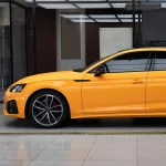 Full front side shot Audi RS wrapped with MOZX Smart McLaren Orange glossy PET vinyl wrap, seamless full body sport racing orange finish