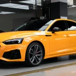 Three-quarter front hero shot Audi RS wrapped MOZX Smart McLaren Orange PET vinyl wrap, bright sport orange performance car display