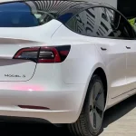 Side rear Tesla Model3 with MOZX Smart White Iridescent Red PET Car Wrap, chameleon color shift texture