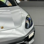 Close-up of MOZX Elite GT Silver TPU wrap on Porsche Panamera hood and headlight