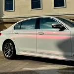 BMW 5 Series side panel close-up MOZX Smart White Iridescent Red PET Car Wrap