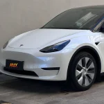 Garage static front shot Tesla Model Y MOZX Smart white iridescent blue PET car wrap