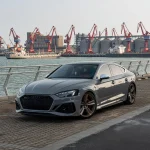 Audi RS5 Sportback wrapped in MOZX Elite Bernina Grey self-healing PET-TPU wrap, mirror high gloss paint protection film at seaside dock