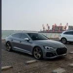 Full side profile Audi RS5 Sportback wrapped MOZX Elite Bernina Grey glossy PET-TPU wrap, seamless fit on curved sport car body panels