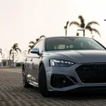 Medium close-up Audi RS5 front matrix LED headlight and RS honeycomb grille wrapped MOZX Elite Bernina Grey PET-TPU wrap, ultra-smooth zero orange peel gloss surface