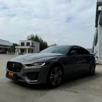 Wide side profile Jaguar XE wrapped MOZX Easy Bernina Grey high gloss PET wrap, luxury sedan metallic grey color change film