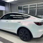 Side rear Tesla Model Y wrapped with MOZX Elite White Iridescent Red TPU chameleon car wrap