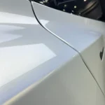 Body panel seam close‑up MOZX Elite white iridescent gold TPU car wrap