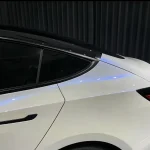 Indoor close‑up car quarter panel MOZX Elite white iridescent blue TPU car wrap