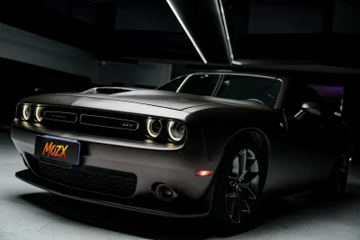 Three-quarter front full shot Dodge Challenger with MOZX Elite Lamborghini Dark Copper self-healing TPU wrap, matte metallic dark copper muscle car color change film