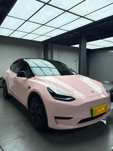 Front 3/4 Tesla Model Y wrapped MOZX Easy Shell Pink glossy PET wrap, MOZX brand display plate