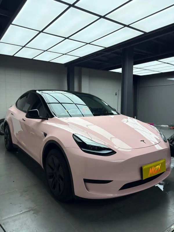 Front 3/4 Tesla Model Y wrapped MOZX Easy Shell Pink glossy PET wrap, MOZX brand display plate