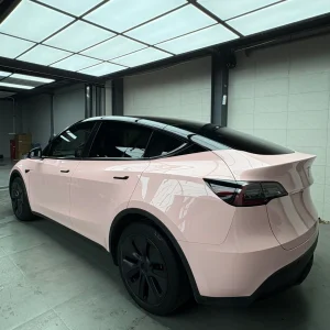 Rear three-quarter shot Tesla Model Y wrapped MOZX Easy Shell Pink glossy PET vinyl wrap, clean rear fender and trunk wrapping edges