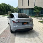 Straight rear shot Tesla Model Y coated with MOZX Easy Nardo Grey glossy PET vinyl wrap, uniform grey finish on rear hatch and bumper