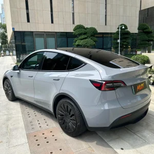 Rear three-quarter shot Tesla Model Y wrapped MOZX Easy Nardo Grey PET wrap, clean trimming around taillights and rear hatch